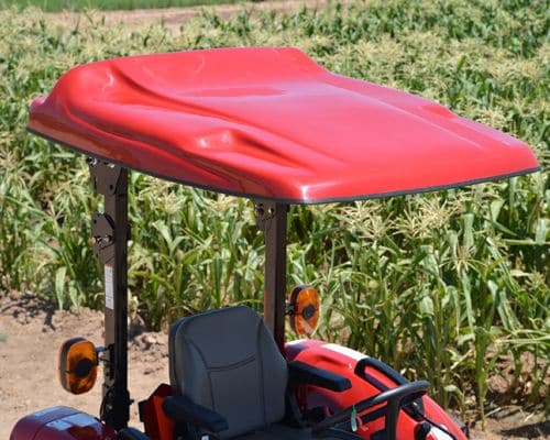 Red fiberglass canopy on a tractor in a cornfield