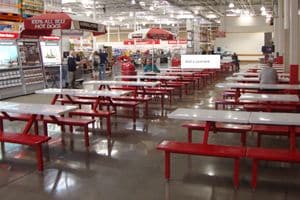 Food court lined with red tables and benches